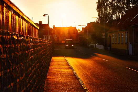 A van driving through town at sunset