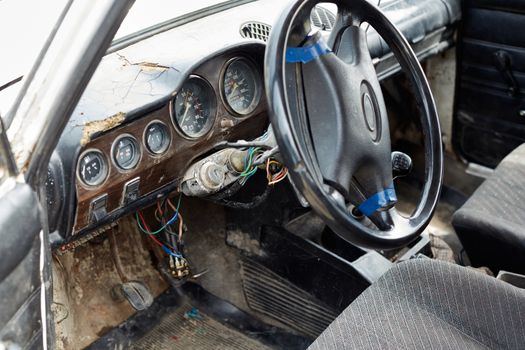 The very damaged interior of an old car from the 1980s