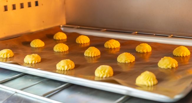 Bakery baker preparing bread cooking in the oven.Bakery close up holding a peel with freshly baked.Activity during quarantine home with family together.