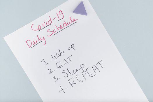 Concept of covid-19 lockdown daily schedule wake up, eat, sleep, repeat quote on paper due to coronavirus outbreak or pandemic