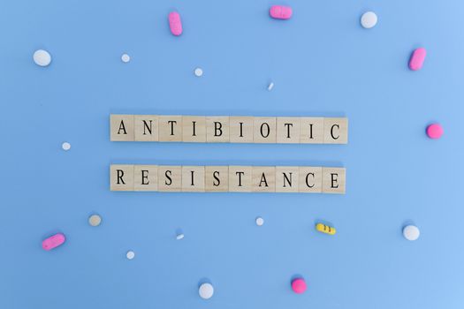 Concept showing of Antibiotic resistance with medicines or pills in wooden block letters