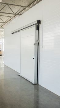 large freezer storage in the factory. closed door from warehouse