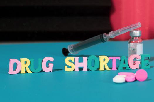 Concept of Drug shortage, Showing with letters, pills and syringe due to global covid-19 or coronavirus pandemic.