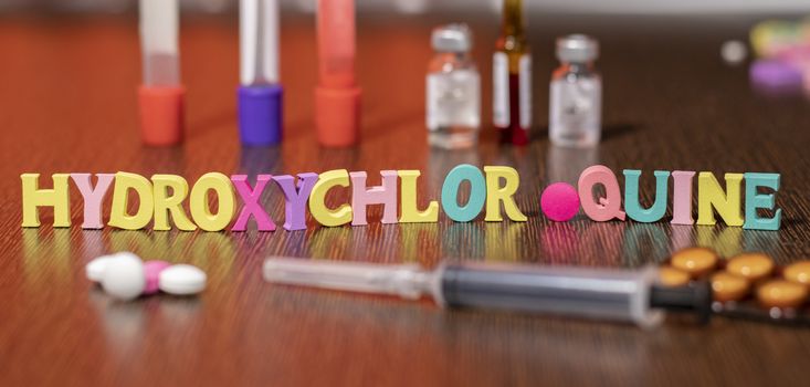 hydroxychloroquine or HCQ drug in colourful letters on table used for malaria