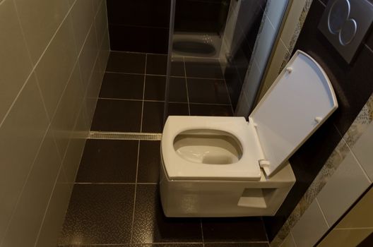 Modern interior toilet with white ceramic toilet bowl in a renovated home, Sofia, Bulgaria