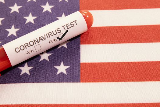 Coronavirus positive test on blood collection tubes on US flag - concept of virus found in USA