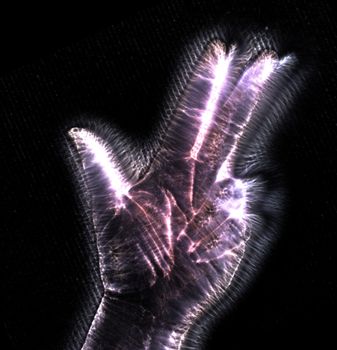 3D-Illustration of a glowing human female hand with a kirlian aura showing different symbols.