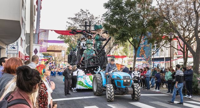 Loule, Portugal - February 25, 2020: Float parading in the street in front of the public in the parade of the traditional carnival of Loule city on a February day