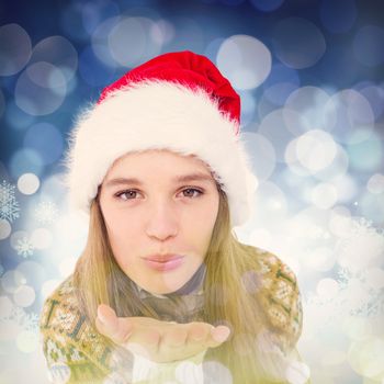 Happy hipster blowing kiss against snowflake pattern