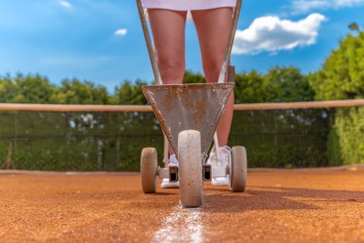 maintenance and repair of tennis courts. drawing white lines with lime.