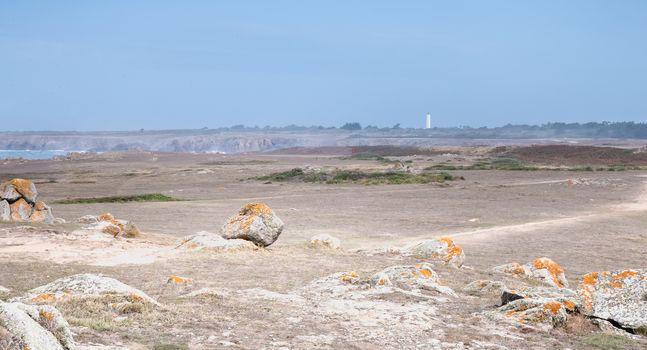 view of the rocky dune of Ile d'Yeu next to the sea with its small beach house, France
