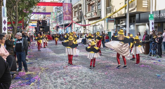 Loule, Portugal - February 25, 2020: dancers parading in the street in front of the public in the parade of the traditional carnival of Loule city on a February day