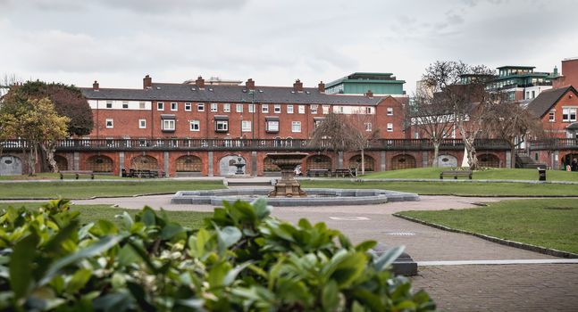 Dublin, Ireland - February 13, 2019: View of the gardens of St Patrick's Cathedral where people are walking on a winter day