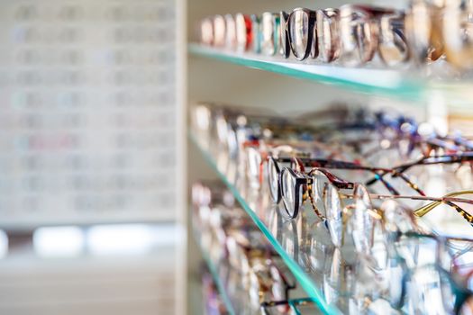 glasses on a display case shelf in an optics store