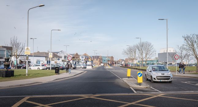 Howth, Ireland - February 15, 2019: people walking in the typical city center of a small fishing port near Dublin on a winter day