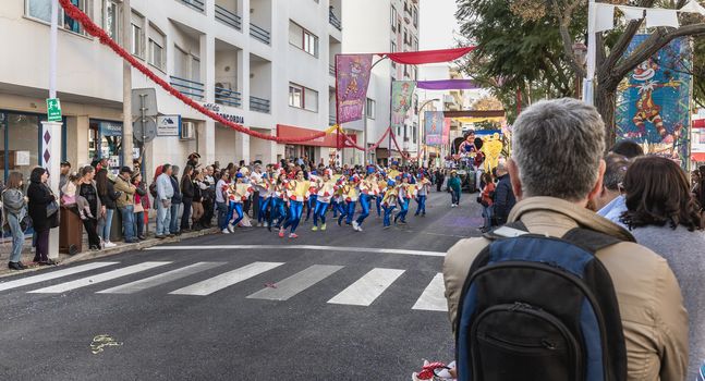 Loule, Portugal - February 25, 2020: dancers parading in the street in front of the public in the parade of the traditional carnival of Loule city on a February day