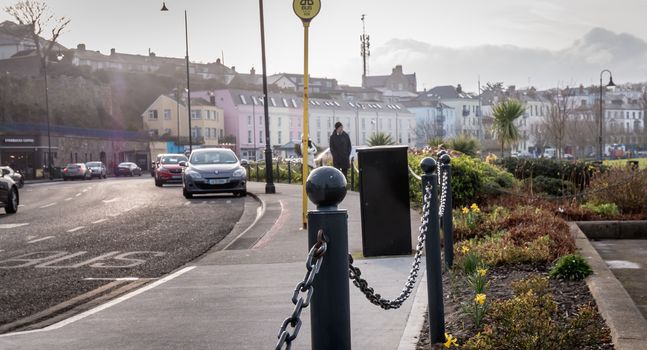 Howth, Ireland - February 15, 2019: people walking in the typical city center of a small fishing port near Dublin on a winter day