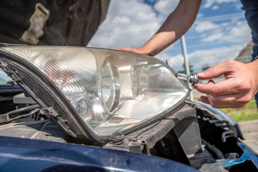 car headlight repair by replacing bad bulbs with new ones.