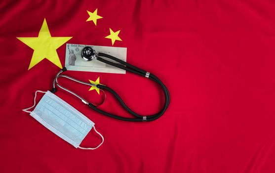 Chinese national flag with United States stimulus check and medical equipment for Covid-19 concept