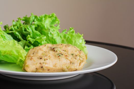 Chicken breast steak with spices serve with fresh green lettuce on white plate. High protein food. Healthy for loose weight.