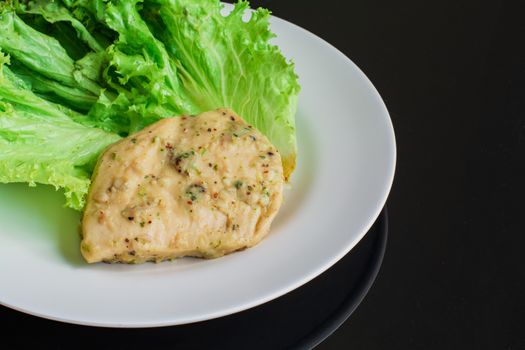 Chicken breast steak with spices serve with fresh green lettuce on white plate. High protein food. Healthy for loose weight.