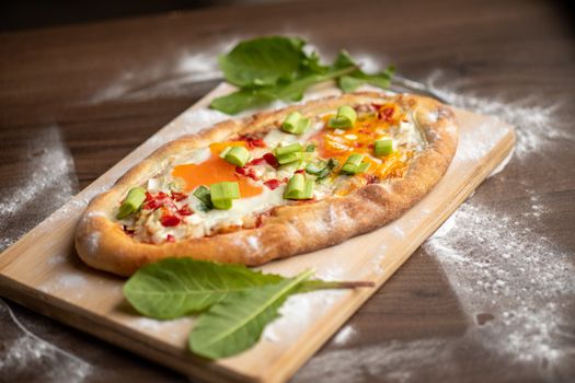 Quick food meal - Egg beacon cheesee pizza decorated with dandelion leafs