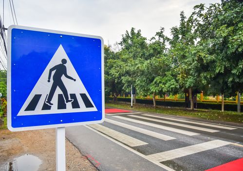 Crosswalk sign on the road for safety when people walking the street