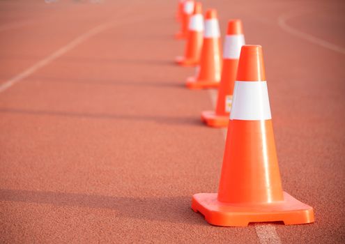 Road cone on orange floor To block the way and indicate