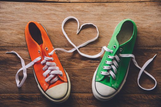 Orange and green sneakers with a rope made of heart style. -Valentine's Day love concept