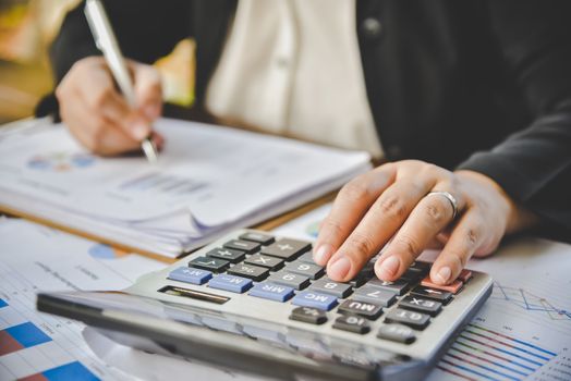 Businessman are working with a calculator and document. Meeting report in progress. in office business concept