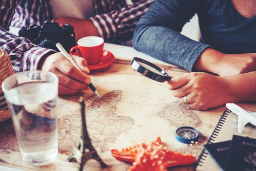 Travelers are planning a trip by searching the route on the map and searching for information on the internet.