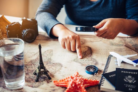 Travelers are planning a trip by searching the route on the map and searching for information on the internet.