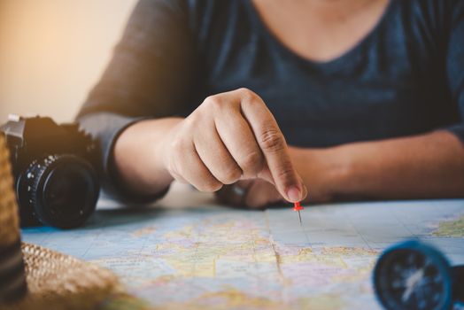 Travelers are planning a trip by searching the route on the map and searching for information on the internet.