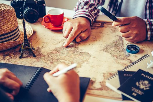 Travelers are planning a trip by searching the route on the map and searching for information on the internet.