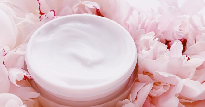 Face cream moisturizer on floral background as luxury skincare cosmetics, healthcare and beauty product concept