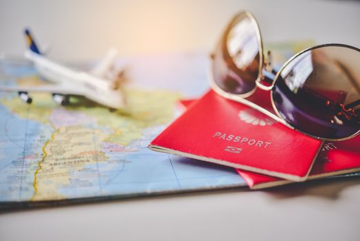 Passport placed on the map concept tourism planning and equipment needed for the trip