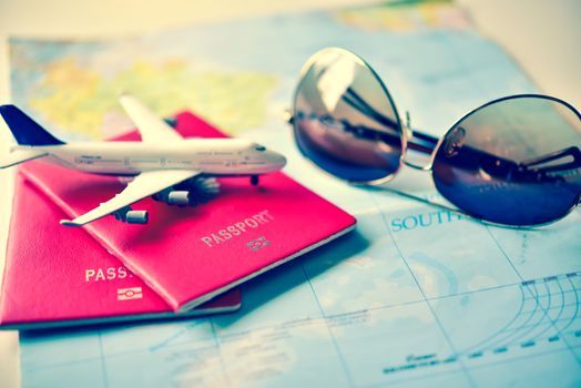 Passport placed on the map concept tourism planning and equipment needed for the trip