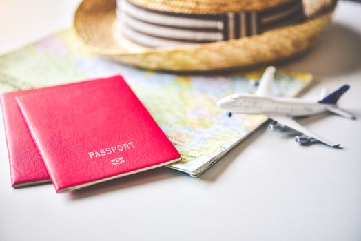 Passport placed on the map concept tourism planning and equipment needed for the trip