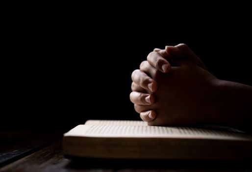 hands woman laying on the biblical while praying for christian religion blessings and Pray to God