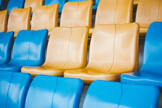 Rows of plastic seats on a grandstand, chair in a stadium, sitting area for spectator