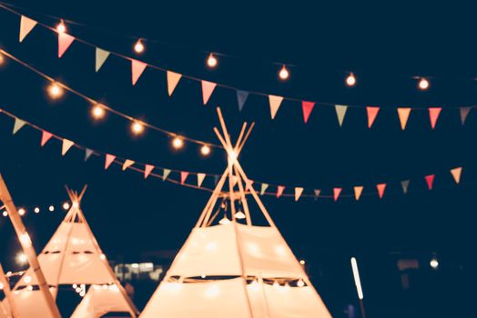 Blurred images of the background party in the festive festivities during the night, consisting of people and glittering bokeh.