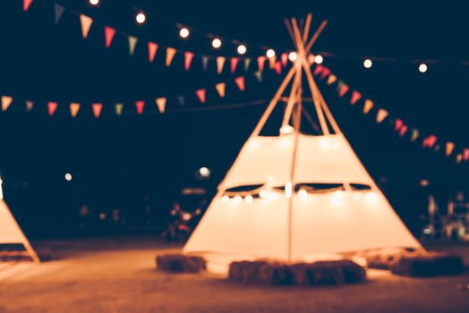 Blurred images of the background party in the festive festivities during the night, consisting of people and glittering bokeh.