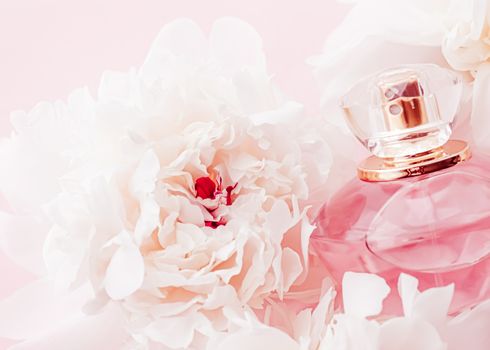 Luxe fragrance bottle as girly perfume product on background of peony flowers, parfum ad and beauty branding design