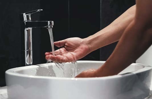 hygiene concept, a man washing hands in the bathroom