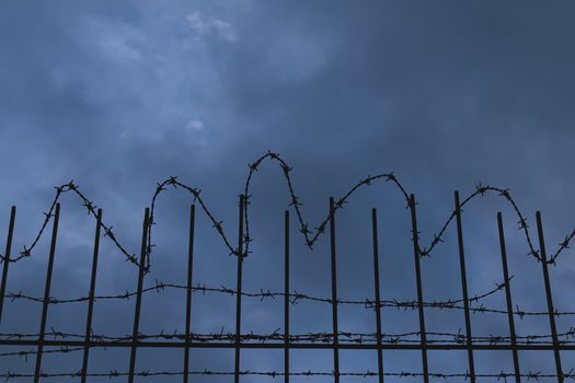 barbed wire fence at night