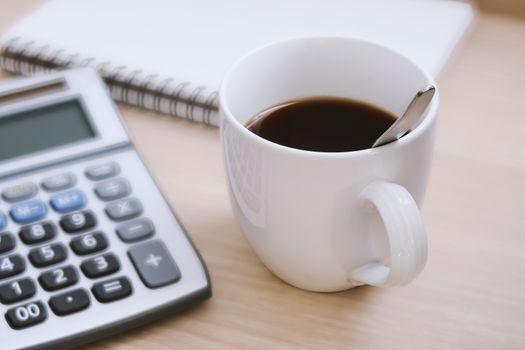 a cup of black coffee on accountant working desk