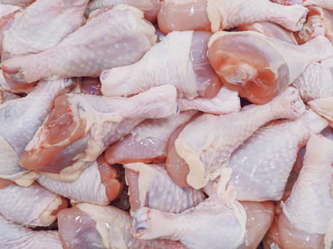 fresh raw chicken legs at market