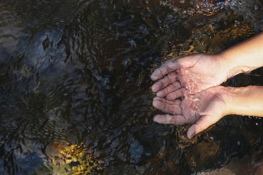 hand of child in water stream