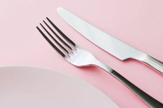 Empty plate and cutlery as mockup set on pink background, top tableware for chef table decor and menu branding design