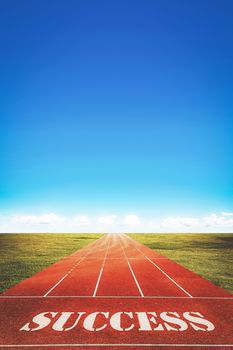 success word on running track and sky background